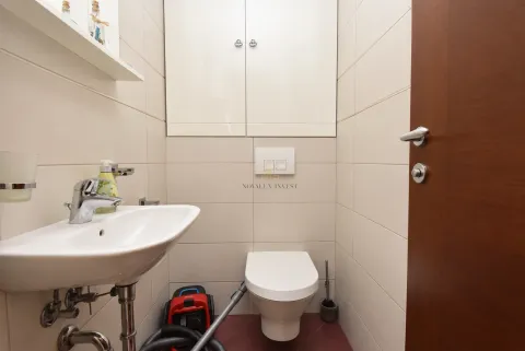 Small bathroom with a washbasin, toilet, and wall cabinet. - image 7