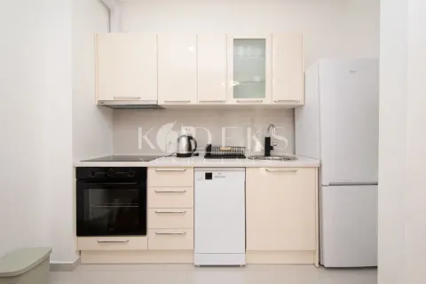 Small bright kitchen with fitted units and white appliances. - image 3