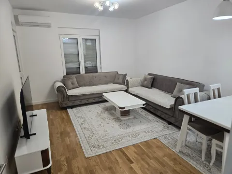 Spacious living room with a sofa set, coffee table, and dining table. - image 12