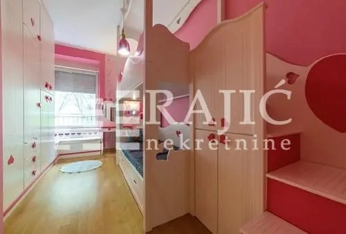 Children's bedroom with bunk beds and pink furniture.