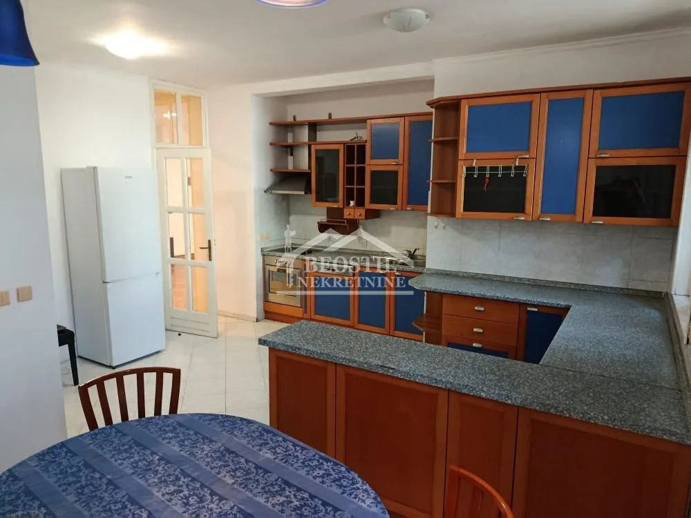 Kitchen with wooden cabinetry and a dining table.