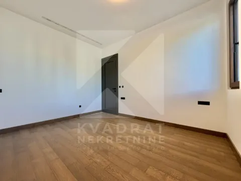 Empty room with wooden flooring and a closed door. - image 9