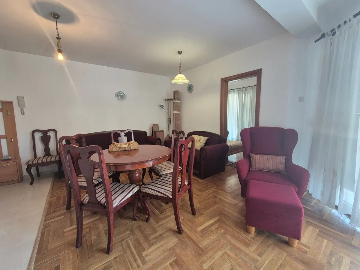 Living room with a dining table and seating furniture.