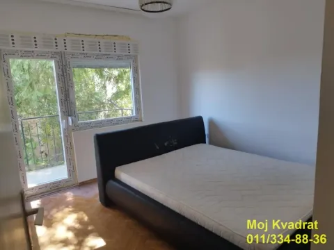 Bedroom with a double bed and balcony doors. - image 4