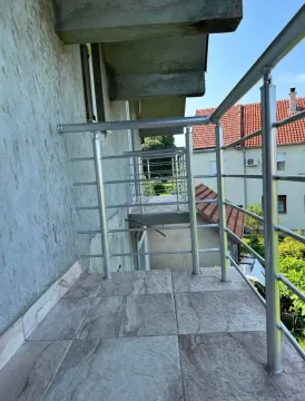 View of a spacious balcony with a metal railing and ceramic tiles. - image 6
