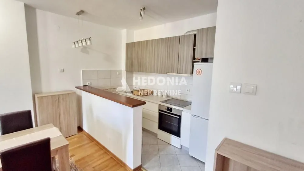 Kitchen with cabinetry and a dining table.