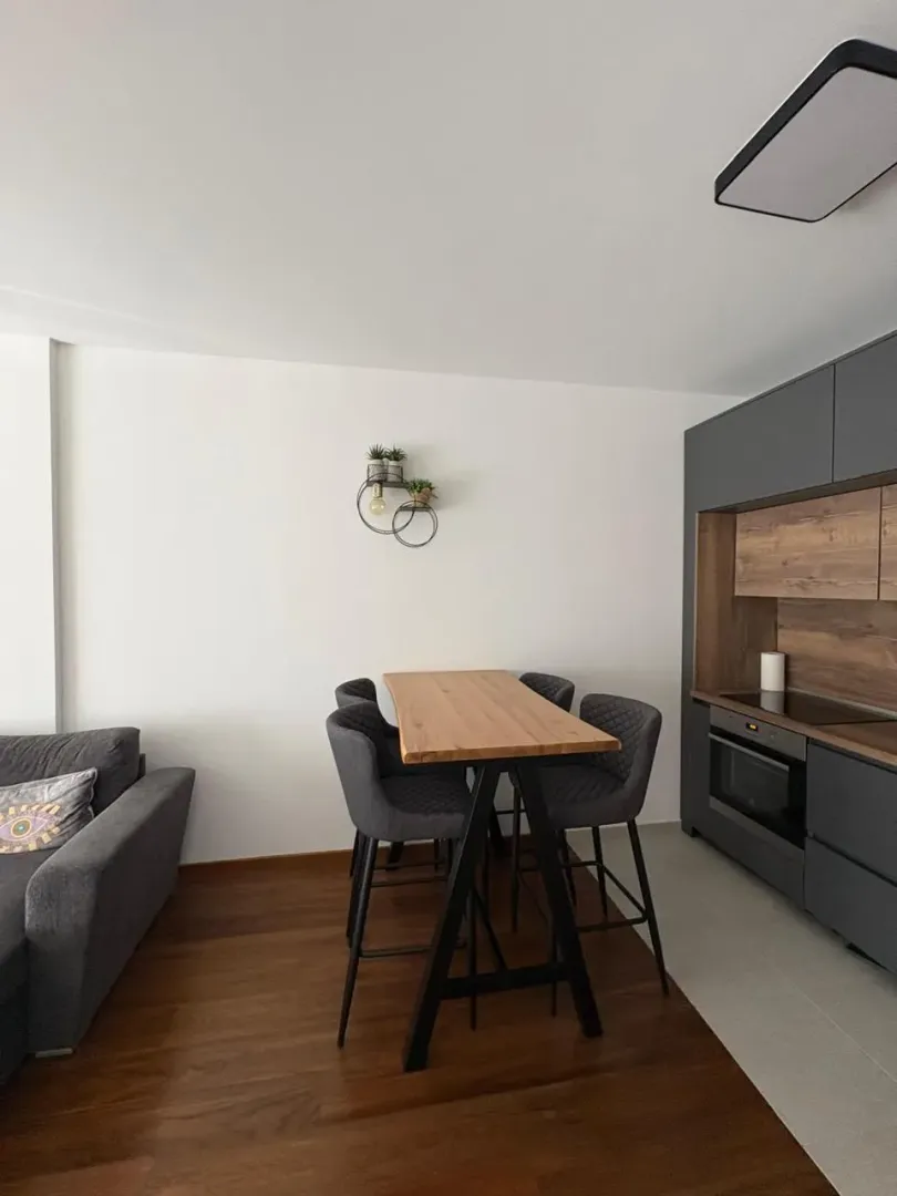 Modern kitchen with a dining table and chairs.