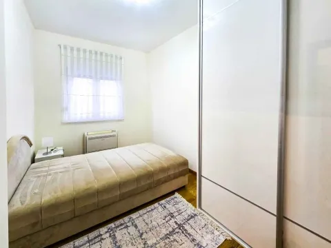 Bright bedroom with a single bed and a large built-in wardrobe. - image 5