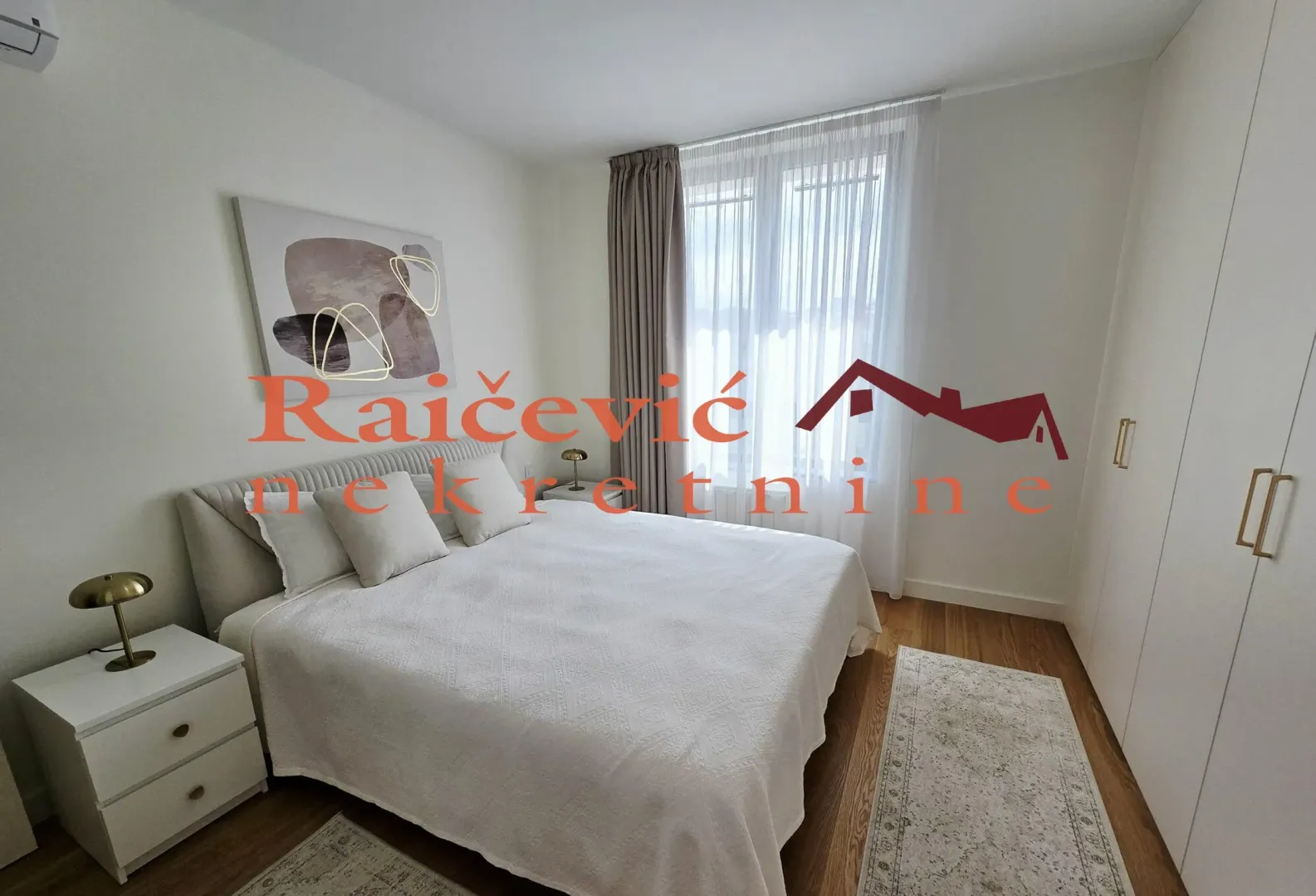 Furnished bedroom with a double bed, bedside tables, and a wardrobe.