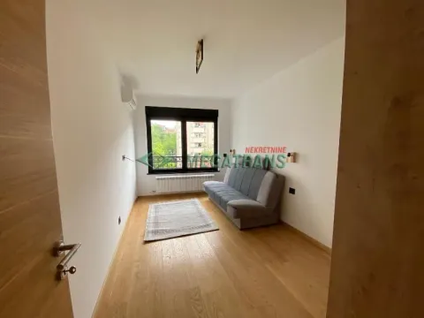 View of the living room with a sofa, rug, and window. - image 15