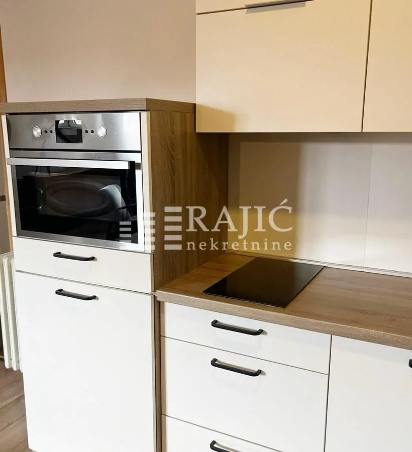 Modern kitchen with built-in elements and appliances.