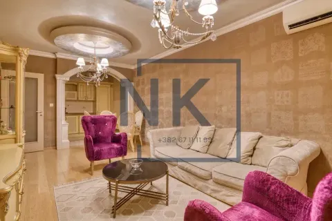 Living room with a sofa, armchairs, coffee table and a view towards the dining area and kitchen. - image 3