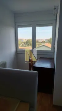 Smaller room with a desk and a view through the window. - image 8