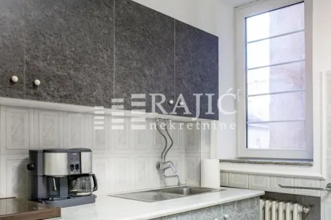 Part of the kitchen with a sink, countertop, and wall cabinets. - image 9