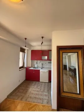 Kitchen with red cabinets and tiled flooring. - image 6