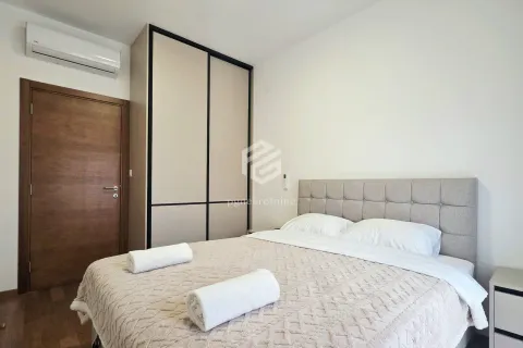 Furnished bedroom with a double bed, wardrobe, and air conditioning. - image 12