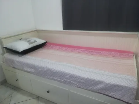 Single bed with drawers in a bedroom. - image 4