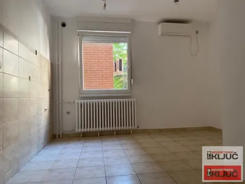Prazna prostorija sa pločicama na podu, prozorom i radijatorom. - image 3