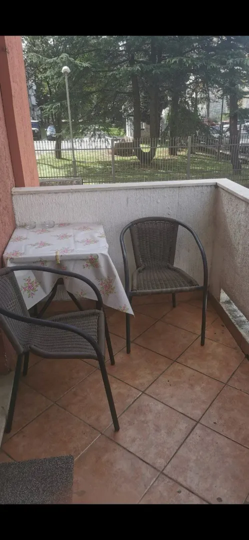 A balcony with a small table and two chairs.