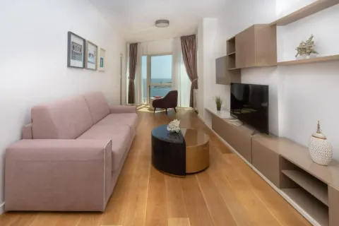 Spacious and bright living room with a sofa and a sea view. - image 18
