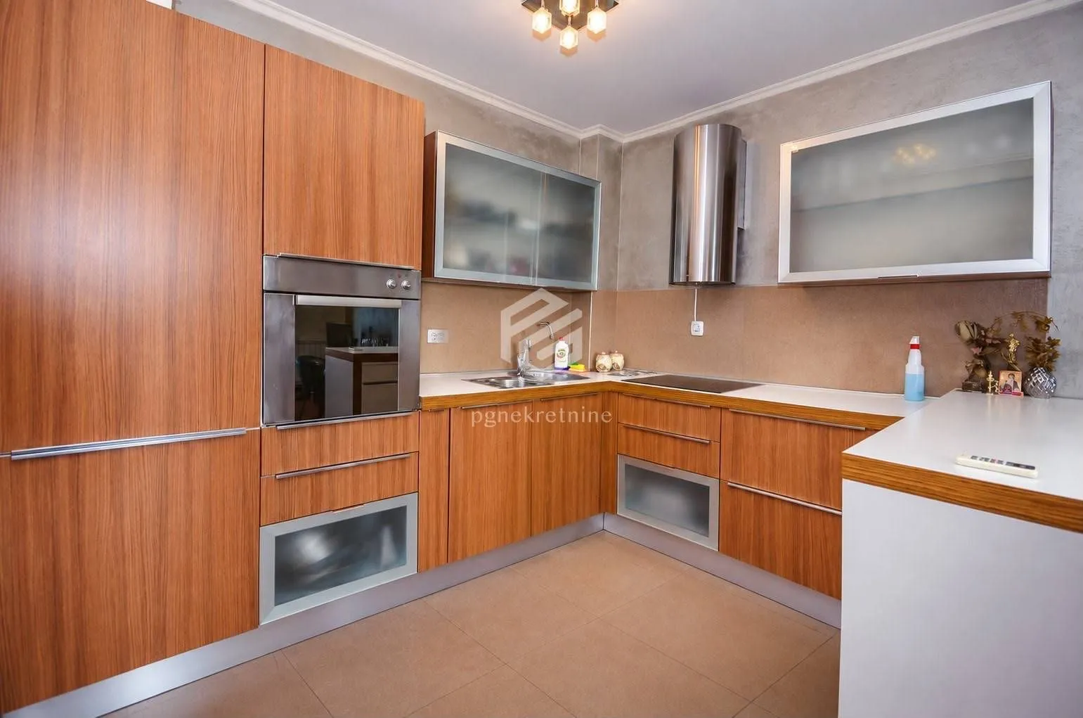 Kitchen equipped with wooden cabinetry and built-in home appliances.