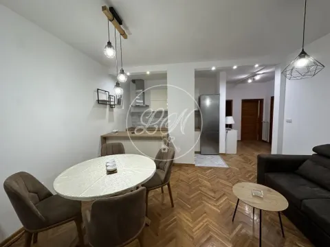 Living room with dining area and part of the kitchen in the background. - image 4