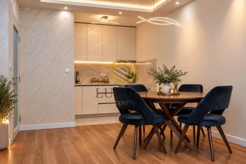 Modern kitchen with a dining area and built-in units. - image 3