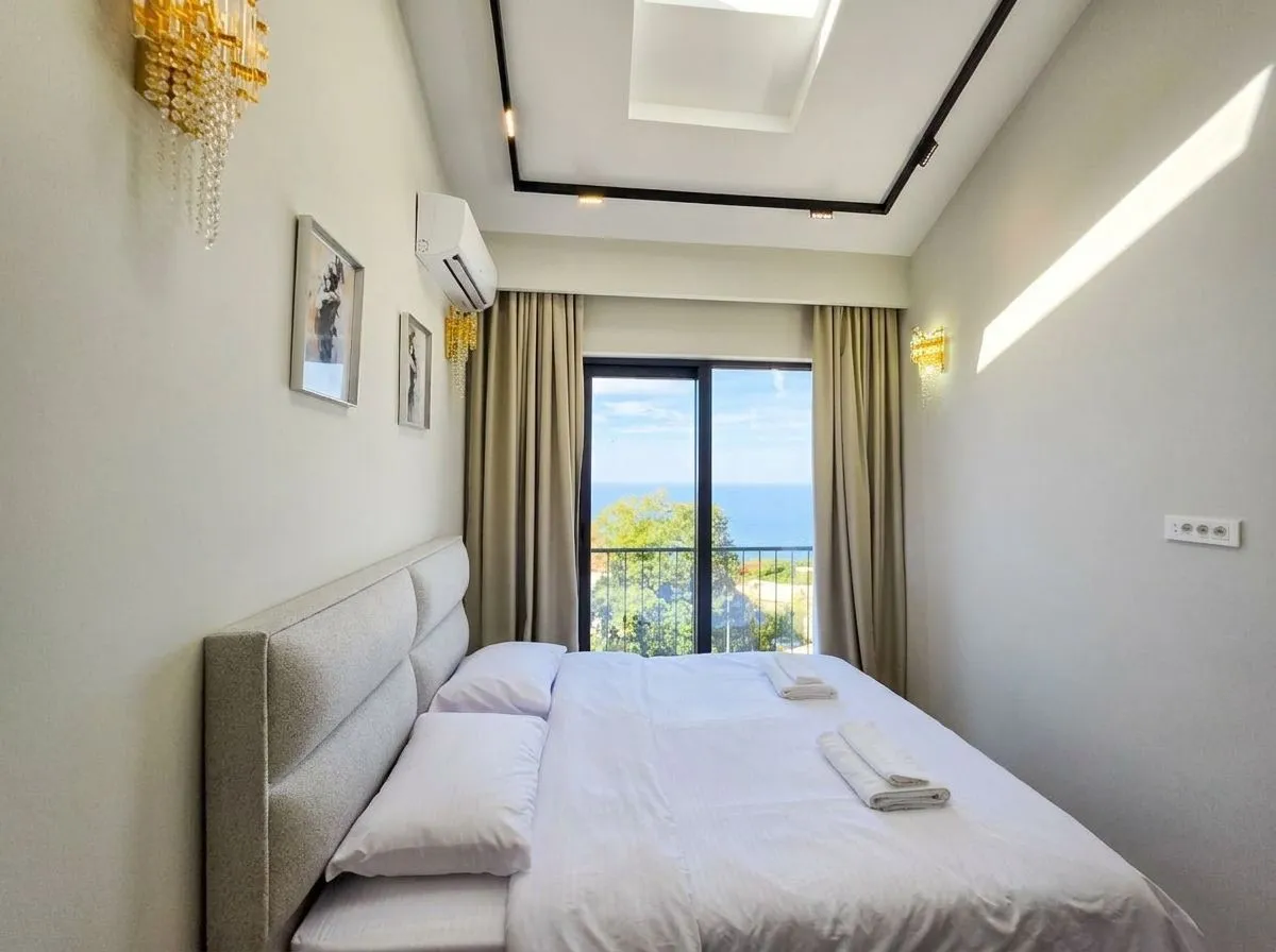 Bedroom with a large double bed and a sea view.