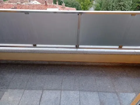View of a spacious balcony with a modern railing. - image 9