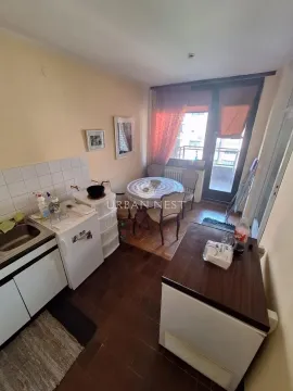 Smaller kitchen with a dining table and access to the terrace. - image 8