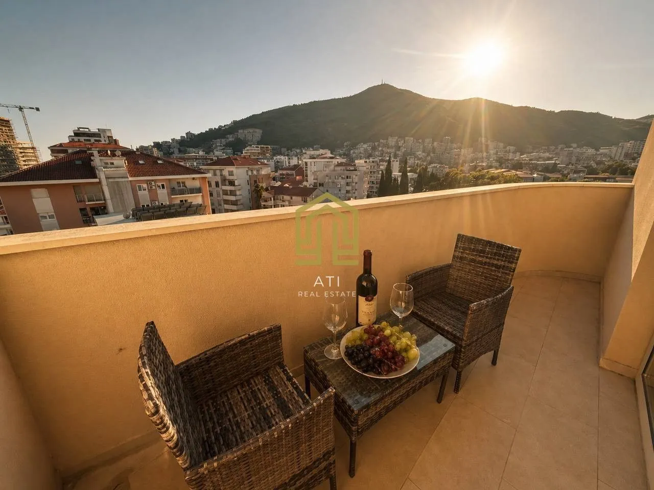 Furnished balcony with seating set and city view.
