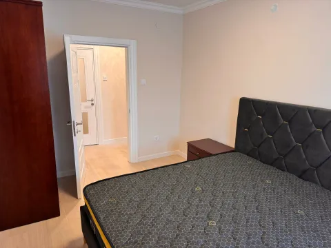 Bedroom with a double bed, nightstand, and an open door leading to the hallway. - image 6