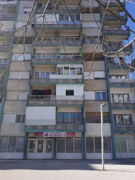 Exterior view of an older residential building with commercial space on the ground floor. - image 7