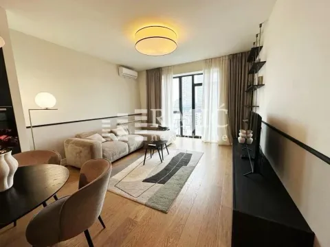 Modern and bright living room with a sofa, dining table, and access to the terrace. - image 5