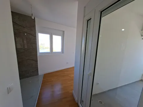 Empty room with parquet flooring, ceramic details, and terrace access. - image 12