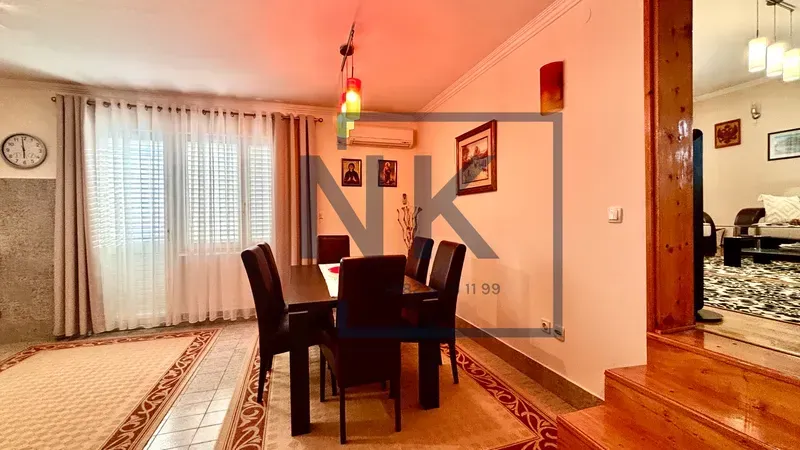 Dining area with a table and chairs, connected to the living room.