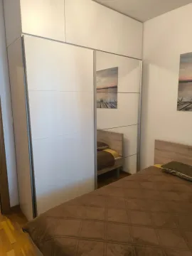 Bedroom with a large wardrobe and a bed. - image 4