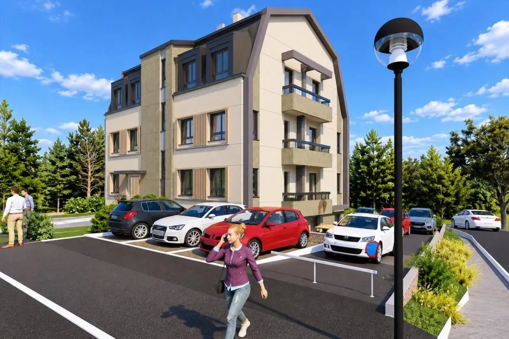 Spoljašnji izgled stambene zgrade sa parkingom i uređenim dvorištem.
