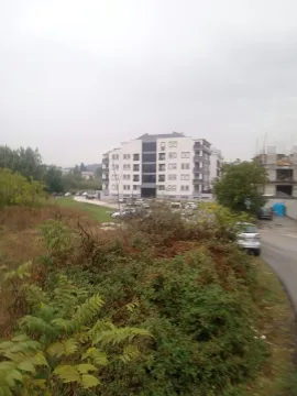 View of a modern residential building surrounded by greenery. - image 15