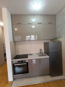 Small kitchen with high-gloss cabinets and built-in appliances. - image 10