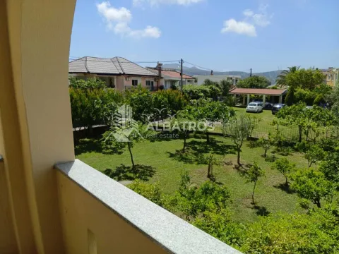 View from the balcony overlooking the green yard and surrounding houses. - image 19