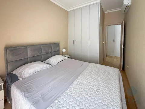 Bedroom with a double bed, large wardrobe and an entrance to another part of the apartment. - image 7
