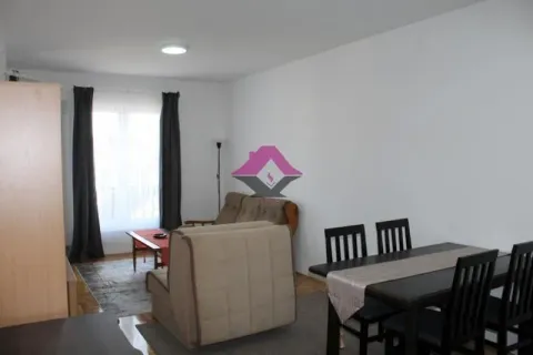 Living room with a sofa, armchair, and dining table. - image 19
