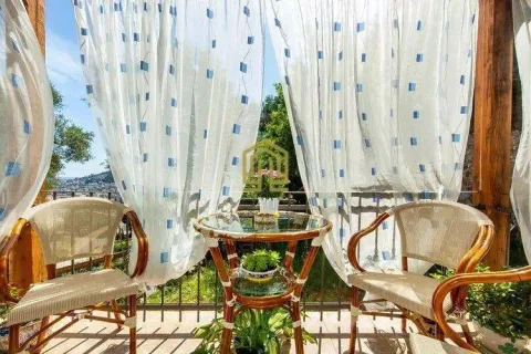 Furnished terrace with a table, chairs, and white curtains. - image 20