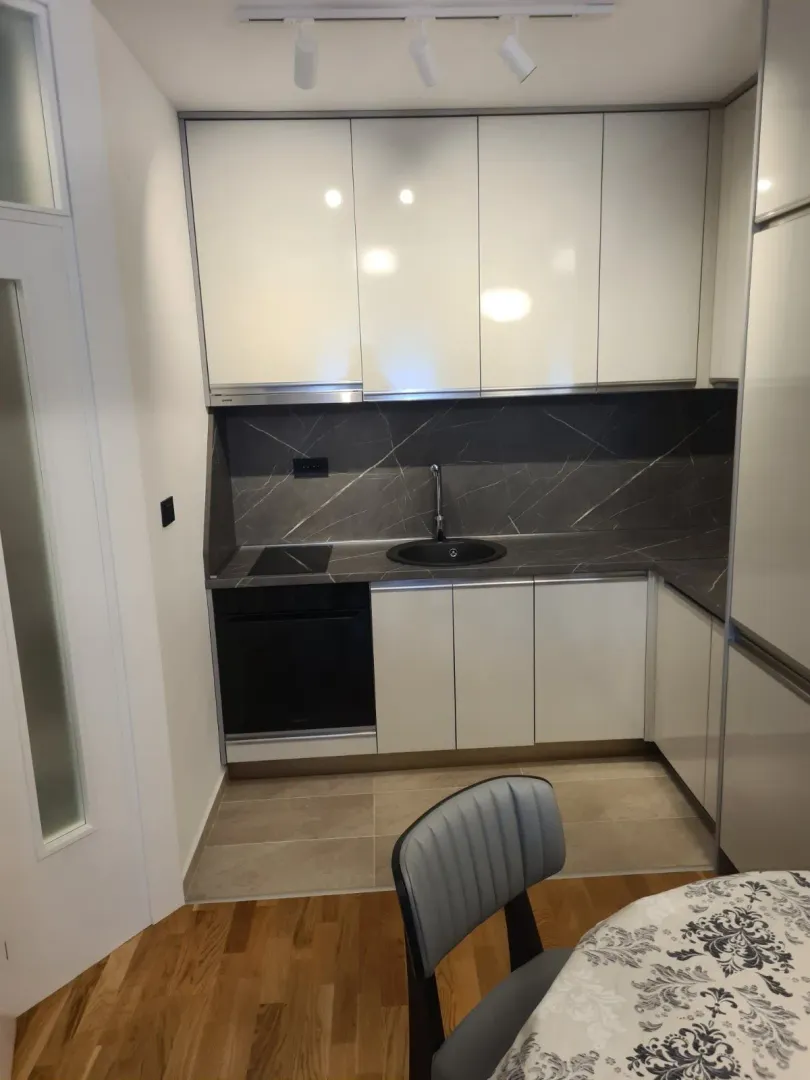 Modern kitchen with white cabinets.