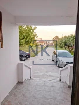Entrance to the house with a view of the courtyard and parked vehicles. - image 13