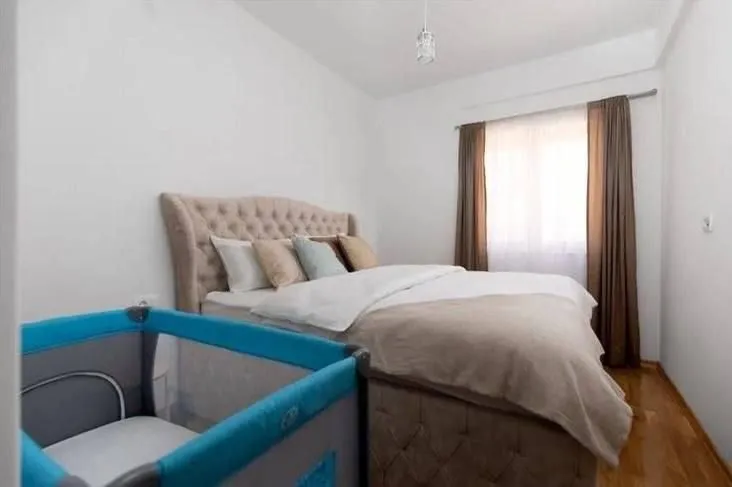 Bedroom with a double bed and a baby crib.