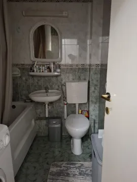 A simple bathroom with a bathtub and toilet. - image 5