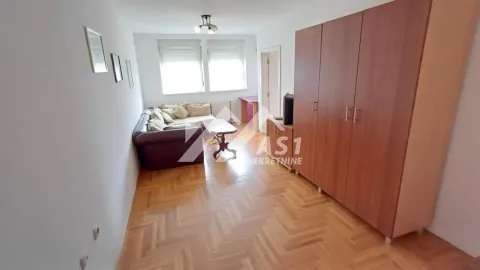 Living room with a sofa set and a large wooden wardrobe. - image 9