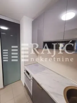 Modern kitchen with built-in cabinetry and appliances. - image 11